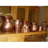 Five antique copper jugs and a copper kettle from England and South Africa and three Turkish