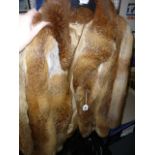 A 'red' fox fur three-quarter length jacket with hidden fastening (upstairs rail by silver shelves)