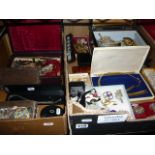 Two cartons of costume jewellery including a musical compact, beads, brooches, etc.