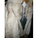 A platinum fox fur three-quarter length jacket with pale blue suede inset strips, wide collar and