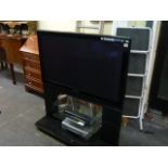 A Panasonic flat screen television with combine stand Skybox, Bush video recorder, a learning remote