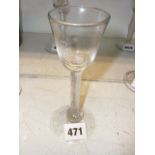 An 18th century wine glass with round funnel bowl on multiple air twist stem with base knop [E]