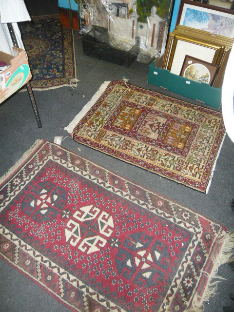 A long blue Eastern corridor rug and three small rugs (floor by Lot 7 and lot 22)