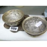 Four Chinese white metal tea bowls with chased decoration and a similar small dish (S)