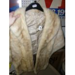 A pale blonde mink cape with long front and shawl collar  (upstairs rail by silver shelves)