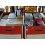 Two boxes of modern literature including Kathyrn Stockett's 'The Help,' Steig Larsson's 'The Girl