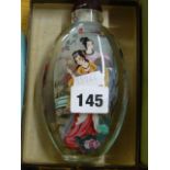 A large decorative Chinese glass snuff bottle with interior painting of female figures dancing and