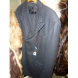 A Dolce & Gabbana gents black suit, sized 36/50 (rail top of stairs)