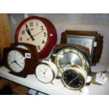 A quantity of vintage clocks including a red bakelite Smiths electric wall clock, further Smiths