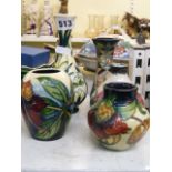 Four modern Moorcroft small vases decorated with lotus and other flowers, variously dated 1995,