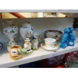 A shelf of decorative china to include a Sylvac cat in a basket (pattern no. 3168), a pair of blue