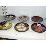Six modern Moorcroft small plates, variously decorated with flowers, variously dated from 2001 to