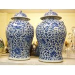 A pair of large Chinese blue and white porcelain baluster jars with domed covers, painted with