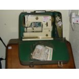 A Bernina electric sewing machine in carry case.