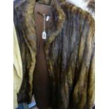A dark brown three-quarter length musquash fur jacket with swing back and turn-back cuffs (rail