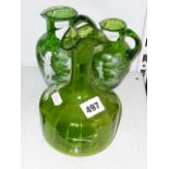 A decanter and two small jugs in green glass with Mary Gregory decoration, c.1900 [P]