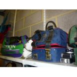 A Wimbledon sports bag full of tennis racquets, two bagged sets of bowling balls one set by