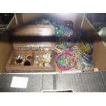 A carton of costume jewellery including lots of colourful beads, brooches, watches, bangles, etc.