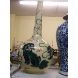 An unusual Chinese large bottle vase enamelled in famille verte with guardian lions and ribbons