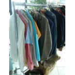 A rail of gents clothing including woollen coats, leather jackets, suits including dress suits,