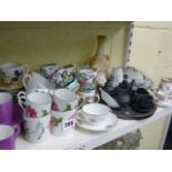 Two Belleek cream glazed cream jugs, a Melitta pewter teapot on tray, a Doulton Burslem cabinet