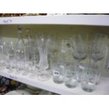 Two shelves of glassware to include red wine glasses, brandy balloons, sherry glasses, drinking