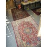 A small Persian rug, the floral design around a central blue cartouche, an old Eastern rug and a