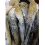 A pale fox fur three-quarter length jacket with hidden fastening (upstairs rail by silver)