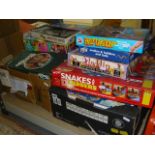 Two crates containing children's board games such as 'Snakes and Ladders,' by Peri Spiele, 'Aladdin,