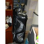 Two golf bags and contents including golden bear fairway golf clubs. (By back doors in garage)
