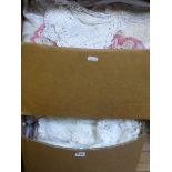 Two boxes of assorted table linen including crochet lace and lace trimmed, bed linen, a cot blanket,