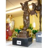 A bronze figure of an exotic maiden holding a stringed instrument, on dark base, 14 ins [M]