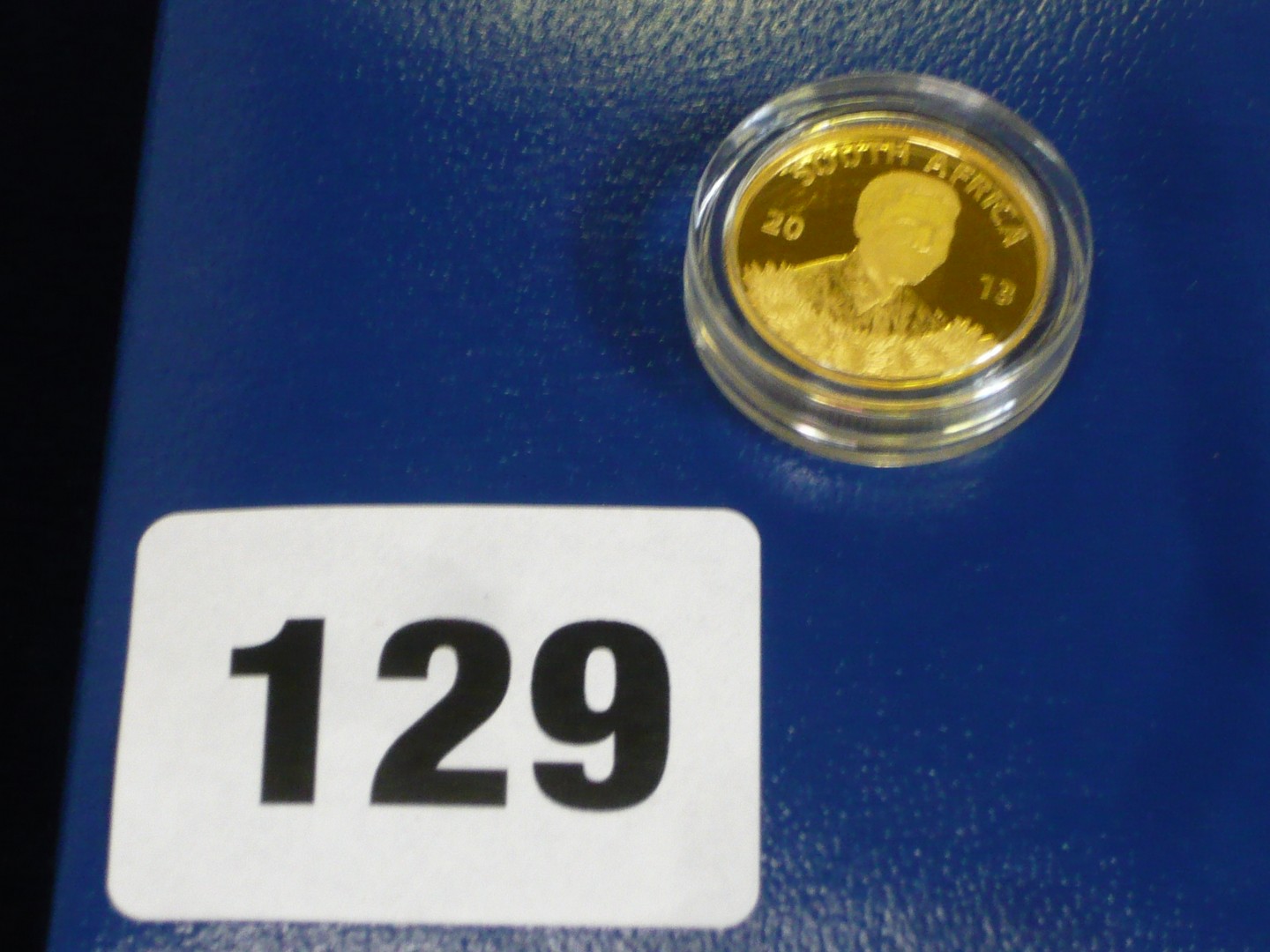 A South Africa '2013 Nelson Mandela' coin in 24 ct gold weighing 3.11g and in original box and