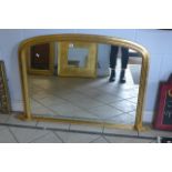 A gilt framed oval mantle mirror.