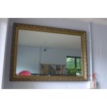 A silver effect bevelled edge mantle mirror and a gilt framed mirror with scrolling leaf and