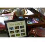 A collection of toys and childhood memorabilia including a Shrek Two Souvenir poster in frame, a