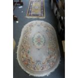 A small rectangular Chinese rug in gold ground with a central floral cartouche and blue outer