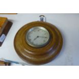 A 1930s wall-hanging timepiece, with bezel-wound movement within a turned mahogany frame, 5 ins