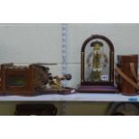 A reproduction Friesian wall clock in oak and gilt-metal, a modern German mantel clock in glazed