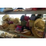 A shelf of assorted ladies hats from the 1960s through to the 1990s, with boxes (empty) and a box of