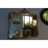 A gilt framed rococo style mirror.