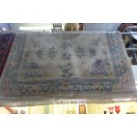 A large Chinese carpet, cream ground and decorated with dragons, bamboo and flowers within a