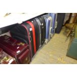 Five suitcases of varying sizes, a quantity of briefcases and sports bags, three small deed boxes