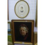 A portrait of an elderly lady wearing a crimson and white bonnet and a black dress with a brooch,