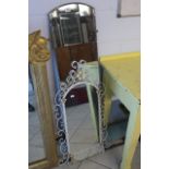 A 1950s metal framed mirror with swirl decoration and a bevelled glass dressing mirror.