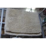 A modern shag pile rug in cream wool. (Railings half landing)