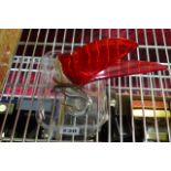 A chrome bird car mascot with transparent red wings.