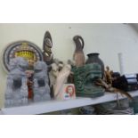 A shelf of decorative oriental items Including a carved pattern wall mask -hand painted, a pair of