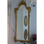 A gilt framed mirror with scrolling leaf and shell motif decoration.