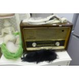 A Grundig wooden cased vintage radio plus fox fur collars and wraps. (by shutters in garage)